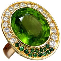 Oval Cut Peridot Cluster 21.00ct. Natural Peridot ring. Oval cut, clean clarity & Transparent. Classic Green Color Clean clarity 19 X 16.5mm 1.00ct Side round diamonds Full cut Brilliants G-color Vs-2 Clarity .50ct round green natural demantoid 14kt. yellow gold 26.8 grams. Ring is 1.18 inch X .99 inch (Top Deck) Depth: .55 inch current ring size: 5 We may resize, please inquire. $18,000 Appraisal Certificate to accompany Fancy Yellow Diamond Ring, Demantoid Garnet, Yellow Diamond Rings, Peridot Jewelry, Purple Jewelry, Gold Cocktail Ring, Natural Diamond Ring, Blue Sparkles, Peridot Ring