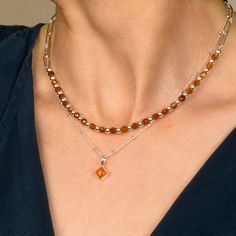 A perfect and unique birthstone gift for those born in July. The diamond-shaped cut Carnelian gemstone is handset into high-quality sterling silver with an 18" eco-silver satellite chain, creating a durable and long-lasting accessory. Each necklace is carefully crafted by skilled artisans with utmost care and attention to detail, making it a rare and beautiful piece of birthstone jewellery.  Carnelian: stimulate creativity | motivation | reduce fatigue We want your jewellery to stay in great con Modern Amber Jewelry For Anniversary, Elegant Brown Necklace With Polished Finish, Elegant Amber Sterling Silver Necklace, Orange Polished Jewelry For Anniversary, Orange Fine Jewelry With Polished Finish, Modern Amber Jewelry With Natural Stones, Orange Gemstone Necklace In Sterling Silver, Modern Silver Jewelry With Gemstone Beads, Fine Jewelry Amber Birthstone