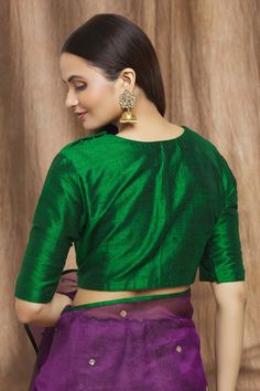 Bottle green saree with round neckline and side zip closure.
Component: 1
Type Of Work: Plain
Neckline: Round
Sleeve Type: Half
Fabric: Degummed Raw Silk
Color: Green
Other Details: 
Note: Saree worn by the model is not for sale
Occasion: Wedding - Aza Fashions Green Traditional Drape Blouse With Self Design, Green Cotton Silk Saree Blouse, Green Saree With Padded Blouse For Navratri, Green Padded Blouse Choli For Navratri, Green Saree With Padded Blouse For Diwali, Green Padded Choli For Navratri, Green Unstitched Cotton Silk Blouse Piece, Green Cotton Silk Unstitched Blouse Piece, Green Cotton Silk Blouse With Pallu