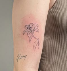 a woman's arm with a tattoo on it that says, happy and a flower