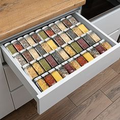 an open drawer in the middle of a kitchen