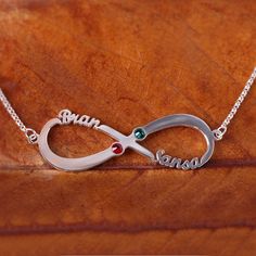 Please pay attention: Only the first letter of the engraving is capitalized! This shimmering Infinity Name Necklace is the perfect way to display your love wherever you go. Choose two names and two coordinating birthstones to make this piece personal just for you and your loved one. Anyone is sure to treasure this timeless silver piece.Chain Type: Width: 44 mmHeight: 14.5 mmThickness: 1.2 mmMaterial: Plating Color: Silver Custom Infinity Jewelry For Anniversary, Adjustable Silver Birthstone Necklace For Anniversary, Silver Custom Name Birthstone Necklace For Anniversary, Personalized Silver Birthstone Necklace For Wedding, Elegant Silver Birthstone Necklace For Personalized Gift, Adjustable Birthstone Name Necklace For Anniversary, Silver Stainless Steel Jewelry With Names, Personalized Silver Stainless Steel Jewelry, Silver Birthstone Necklace With Custom Name For Anniversary