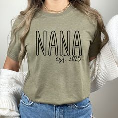 Custom Nana Shirt, Nana Est Shirt, New Nana Gift, Gift for Nana Shirt, Nana Shirt, Nana Est Custom, Personalized Nana Shirt We provide a variety of products for you to choose from with the same designs such as T-shirt, Sweatshirt, Hoodie. They are utilitarian, comfortable, and can be worn while running errands on a weekend or just lounging around the house on a cold winter day. All of our shirts are custom-made-to-order and handcrafted to the highest quality standards. Product Features: Made and shipped in the USA , T-shirts boast superior quality, thanks to advanced manufacturing, rigorous quality control, and ethical labor practices, ensuring durability and excellence 100% Cotton. This Shirt features breathable fabric, excellent stretch, and wrinkle resistance, providing comfort and main Green Short Sleeve Tops With Name Print, Green Short Sleeve Top With Name Print, Casual Relaxed Fit Shirt With Name Print, Basic Crew Neck Shirt With Name Print, Relaxed Fit Graphic Tee With Name Print, Graphic Tee Shirt With Name Print In Relaxed Fit, Casual Crew Neck Top With Name Print, Casual Long Sleeve Shirt With Name Print, Green Relaxed Fit Top With Name Print