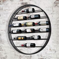 a round metal rack with wine bottles on it