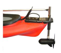 an orange kayak sitting on top of a white surface with two black wheels attached to it