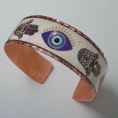 Copper Bangle with Enamel Evil Eye and Hamsa Designs - Sacred Crystals Bracelets Hand Painted Bohemian Bangle Jewelry, Bohemian Hand Painted Bangle Jewelry, Bohemian Hand-painted Bangle Jewelry, Adjustable Enamel Cuff Bracelet As Gift, Adjustable Enamel Bangle As A Gift, Adjustable Enamel Bangle As Gift, Adjustable Enamel Cuff Bracelet For Gift, Adjustable Enamel Bangle For Gift, White Enamel Bohemian Jewelry