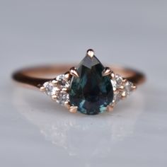 a blue diamond ring with three diamonds around it