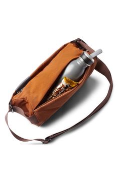 a brown bag with a bottle in it on a white background and a strap around the bottom