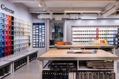 the interior of a book store with many books on shelves and an open area for reading