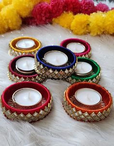 colorful candles are sitting on a white fur