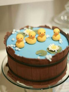 a cake decorated with rubber ducks and water lilies