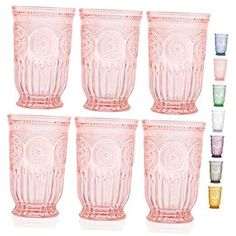 six pink glass tumblers with different designs and colors on the bottom, all lined up in rows