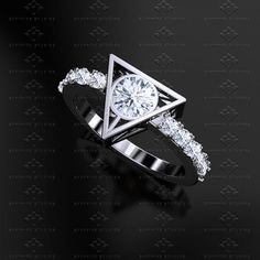 a diamond ring on a black surface with diamonds around the band and an open triangle design