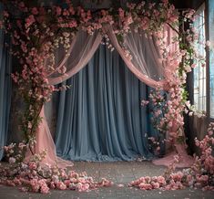 an image of a stage set up with flowers on the floor and drapes over it