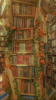 a bookshelf filled with lots of books and flowers