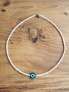 Handmade White Bohemian Charm Necklaces, Trendy Adjustable Evil Eye Necklace, Trendy Adjustable Evil Eye Necklaces, Adjustable White Charm Necklace Choker, Handmade White Charm Necklace Choker, White Handmade Dainty Choker, Handmade Dainty White Choker, White Dainty Handmade Choker, Dainty Handmade White Choker