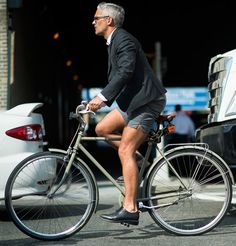 a man riding a bike down the street