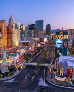 an aerial view of the las vegas strip at dusk with many buildings and cars driving on the road