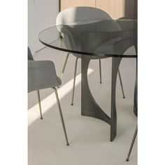 a glass table with chairs around it