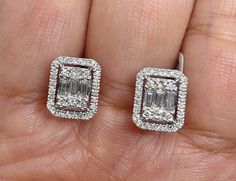 Classy Diamond Earrings Emerald Cut Halo Studs. Nice size earrings you can dress up or down with. Excellent craftsmanship, all diamonds are set smooth. Lays nice on the ear. These square shapes are a bit different than your everyday round ones. The push backings have double notches for a secure fit. Measures 10.1 x 9mm. These natural diamonds are nice and sparkly. Genuine Round, Princess and Baguette Cut Diamonds Total weight: 0.98 Carats Clarity: SI Color: G All white and shiny diamonds, no clo Luxury Rectangular Diamond Earrings In Prong Setting, Classy Diamond Earrings, Luxury Square Cut Diamond Accent Earrings, Luxury Radiant Cut Earrings With Vvs Clarity, Luxury Rectangular Earrings For Anniversary, Luxury Diamond Rectangular Earrings, Diamond Square Earrings, Emerald Cut Earrings Studs, Earrings Gold Diamond