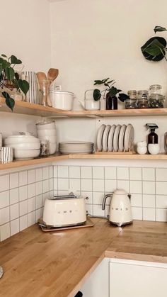 an image of a kitchen setting with dishes on the shelves