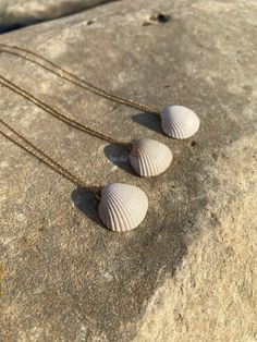 Shell necklaces with an artisanal, minimalist, and timeless design. These shells are collected from the beaches of San Sebastián and Hondarribia in northern Spain. They are the perfect addition to your summer looks. They are also a great gift for a loved one. Made with 925 sterling silver and gold-plated. The shell may vary in size, shape, and color, making these necklaces unique. Designed and assembled by hand in San Sebastian (Spain). Clean with a cotton cloth, and do not moisten or spray them Dainty White Shell Necklace, Dainty Shell Jewelry For Beach, Beachy Strand Necklace For Gift, White Coastal Style Necklace For Gift, Coastal Style White Necklace For Gift, Coastal Style White Necklace As Gift, Coastal Style Shell Jewelry For Gifts, Coastal Strand Necklace As Gift, Coastal Strand Necklace For Gifts