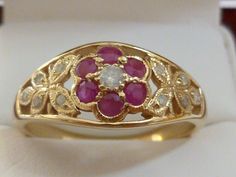 This Beautiful Vintage Inspired Ruby & Diamond Flower ring has been crafted from 9ct Solid Yellow Gold. A claw set GENUINE Natural Earth Mined Diamond and surrounding NATURAL Ruby petals with milgrain edging brings this ring to life. Resting on the shoulders of this splendid ring are exotic butterflies which have been inset with diamonds. THIS VINTAGE INSPIRED RUBY & DIAMOND FLOWER-BUTTERFLY RING IS TRULY AN EXQUISITE FINE JEWELLERY PIECE WHICH IS TO BE TREASURED FOR A LIFETIME ! ------- Exotic Butterflies, Diamond Butterfly Ring, Ruby Flower, Diamond Flower Ring, Diy Jewelry Rings, Diamond Butterfly, Flower Butterfly, Butterfly Ring, Ring Antique