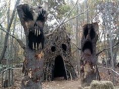 an old tree house in the woods with scary teeth on it's face and mouth