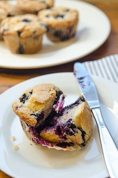 two plates with muffins on them and one has blueberries in the middle