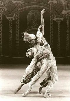 two people are performing an artistic dance on stage