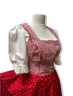 Beautiful dirndl dress red and white Bavarian crop top in perfect condition. The upper part has a corset detail and it is fully lined.   One side pocket measurements laying flat for dress and apron Distance between shoulders 32 cm Waist 72 cm length 135 cm Bust 90 cm Size on label D38  Includes also crop top  Measurements for top 100% cotton with big puffy sleeves  Distance between shoulders 32 cm Length 31 cm Bust  92 cm Sleeve length 35 cm The waist is elasticated. The top shows minor signs of Red Dirndl, Floral Apron, Dirndl Dress, Top Measurements, Puffy Sleeves, Dress Red, Set Vintage, Dress Clothes For Women, Side Pocket