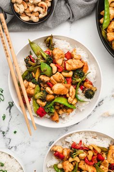 chicken and broccoli stir fry with white rice on a marble countertop next to chopsticks