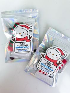 two packaged candy bags with snowman stickers on them