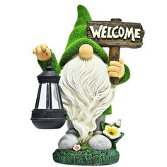 a garden gnome holding a welcome sign