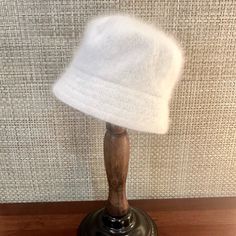 This Spectacular Winter White Angora Cloche/Bucket Hat By Cappelli Of New York Is Super Stylish And Warm! Fine Angora Fibers, Known To Be Softer Than Cashmere, Come From The Domestic Angora Rabbit. Angora Wool Is One Of The Most Sought After Materials For Making The Soft And Warm Winter Gear We All Love!Interior Is Unlined And Has Matching Color Sweatband. Wear With Short Or Long Haira Staple Accessory For Every Hat Wearer This Fall And Winter! About Gma Accessories Inc: Gma Accessories Inc., Do Brimmed White Bucket Hat, White Brimmed Bucket Hat For Winter, White Winter Bucket Hat With Short Brim, White Short Brim Bucket Hat For Winter, White Casual Cloche Hat For Winter, Classic White Bucket Hat With Short Brim, White One Size Bucket Hat, White Curved Brim Bucket Hat For Winter, White Brimmed Hat One Size