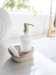 a bottle of soap sitting on top of a sink