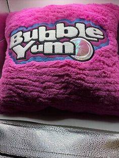 a pink pillow that says bubble yum on it