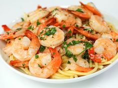 pasta with shrimp and parsley in a white bowl