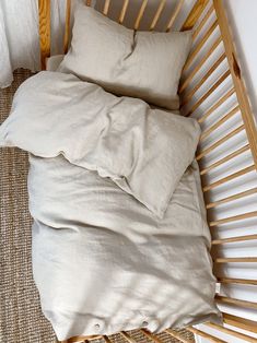 an unmade bed with two pillows on it