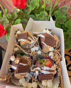 a box filled with lots of different types of desserts on top of a table