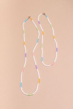 We love our single strand handbeaded necklaces so much that we decided to add a new length! Say hello to Quinn! This necklace is meant for layering, put Quinn with your gold chains, mix her up with another beaded necklace or just wear her solo. Now available in white stripe, vibrant white strand with pops of mint, bubblegum pink, soft purple, and electric blue. - single strand handbeaded multi colored necklace - gold filled lobster claw closure - handmade in Mexico - 23” fixed length Diy Choker, Colored Necklace, Phone Items, Multi Coloured Necklaces, Themed Jewelry, Colourful Necklace, Bubblegum Pink, Beaded Choker, Hand Beading