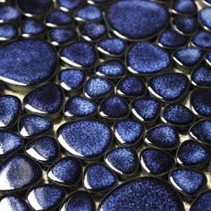 close up view of blue glass circles on a surface that looks like something out of space