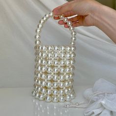 This handmade pearl bucket bag, designed to add elegance to your special occasions, dazzles with its pearl bead details. Whether paired with a wedding gown or used to complete your evening ensemble, this bag will always make you feel chic and special. Features: -Meticulously crafted by hand, with every detail delicately executed. -Made with high-quality pearl beads, exuding elegance with every touch. -Offers the option of shoulder or hand carrying thanks to its adjustable chain strap. -Includes Formal Bucket Shoulder Bag With Pearl Handle, Pearl White Shoulder Bag With Pearl Handle For Events, Elegant Bucket Shape Shoulder Bag For Gift, Elegant Bucket Evening Bag For Wedding, Elegant Bucket Shape Shoulder Bag As Gift, Cream Bucket Bag With Pearl Handle, Elegant Wedding Bucket Evening Bag, Elegant Bucket-shaped Bag For Gifts, Elegant Bucket-shaped Bag As A Gift