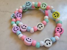 "A cute smiley necklace! Made with a mixture of pastel colored smiley beads and pastel pink, blue, mint and white pony beads. Measures ~18\" made with stretchy elastic." White Playful Friendship Necklace, Playful White Friendship Necklace, Playful Pink Necklace For Everyday, Pink Letter Beads Fun Necklaces, Fun Pink Beaded Necklaces, Fun Pink Beaded Necklaces With Letter Beads, Fun Pink Beaded Necklaces With Round Beads, Pink Beaded Necklaces With Round Beads, Fun Style, Fun Pink Adjustable Beaded Necklaces