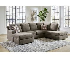 a living room with a sectional couch and rug