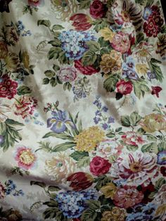 a chair covered in floral fabric on the floor