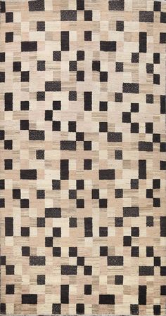 an area rug with black and white squares on the top, in various shades of brown