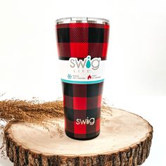 This is a red buffalo plaid cup in red and black, with a silver metallic top. This cup is taken on top of a slab of wood with a brown plant in the side  as decor. Cabin Chic, Red Buffalo Plaid, Giddy Up Glamour, Trendy Tree, Tree Farm, Tree Farms, Plaid Design, Copper Plated, Favorite Drinks