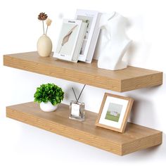 two wooden shelves with pictures and vases on them