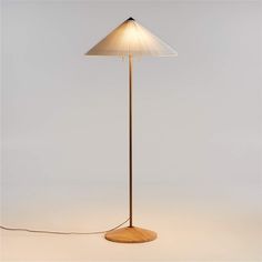 a floor lamp with a wooden base and white lampshade on the top one